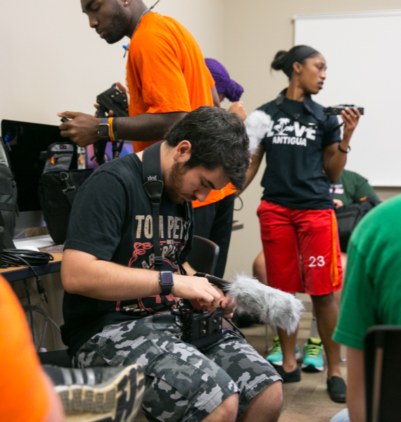 A student looks at the back of a digital camera